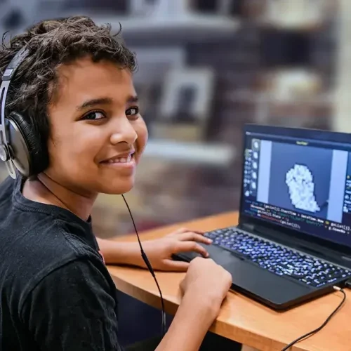 Child at home taking part in an online minecraft course